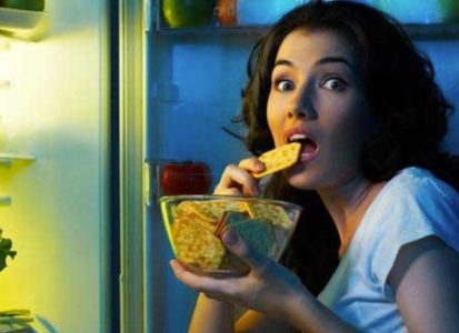 Snack Right, Stay Light Woman holding a potato chip from a bag